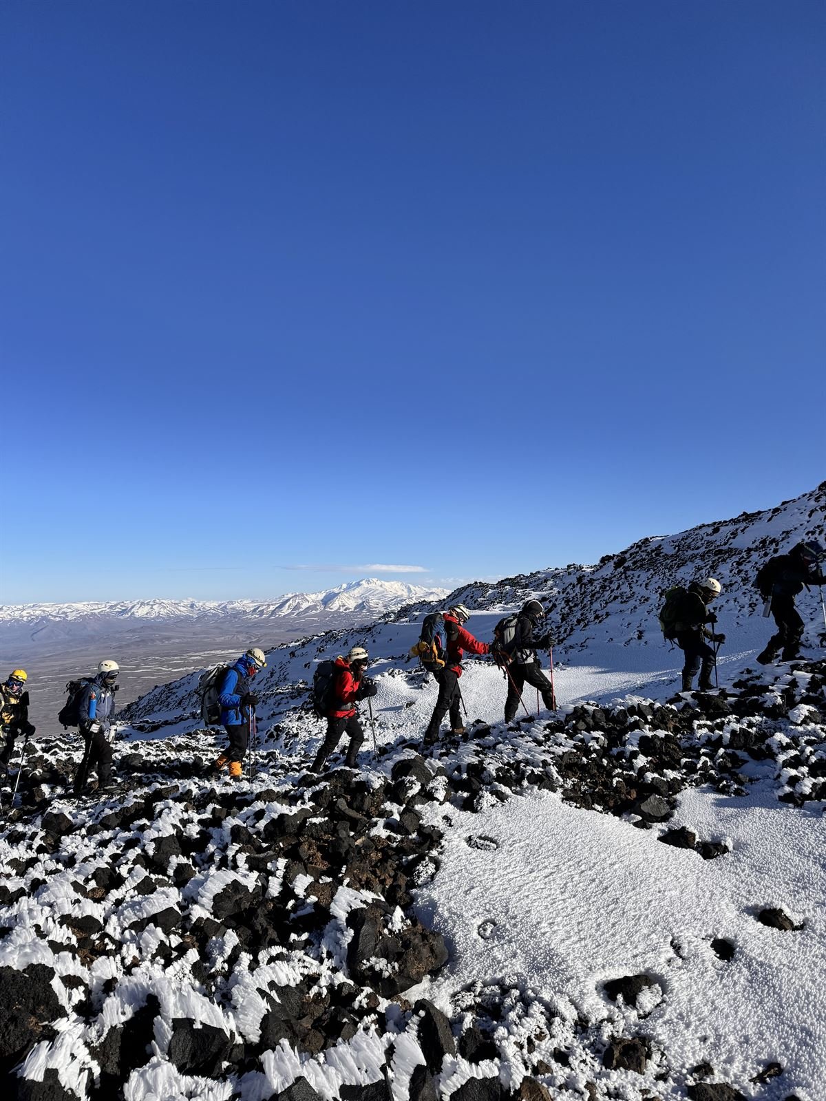 Grupo ascendiendo en fila hacia la cumbre del Tromen